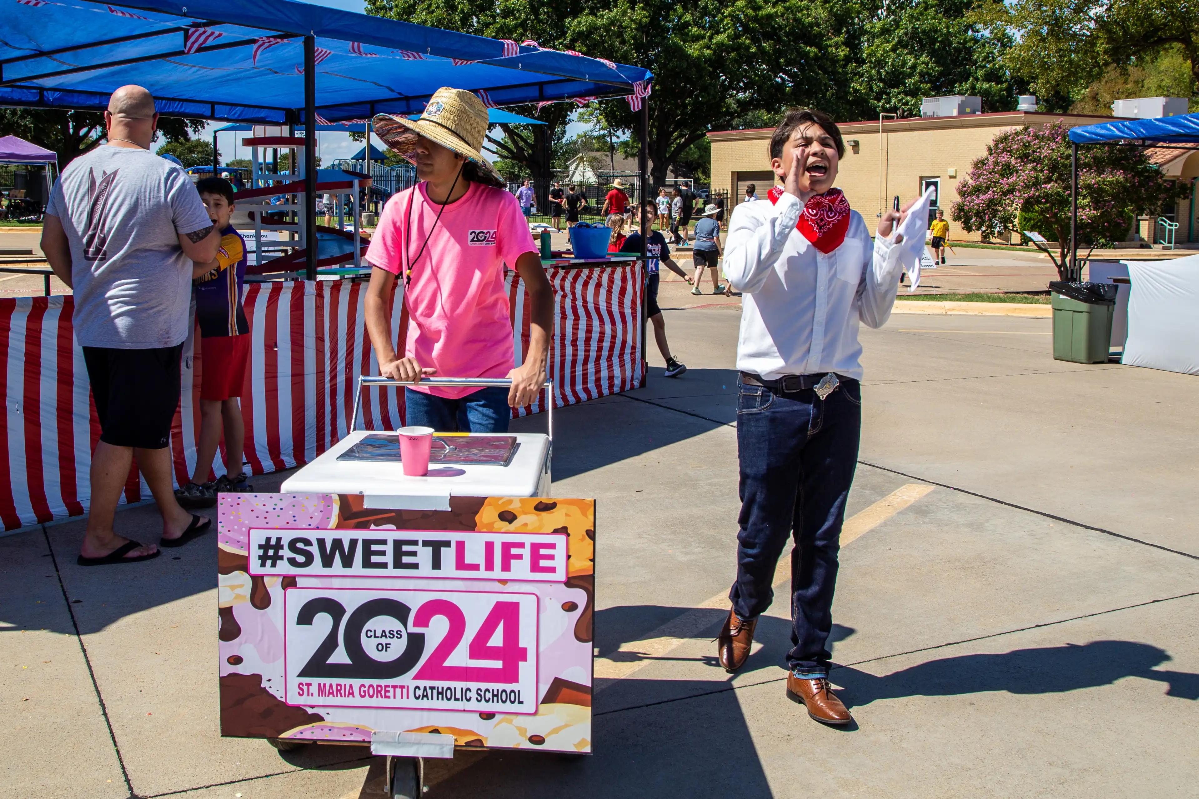 two students selling paletas from a rolling cart at GorettiFest festival