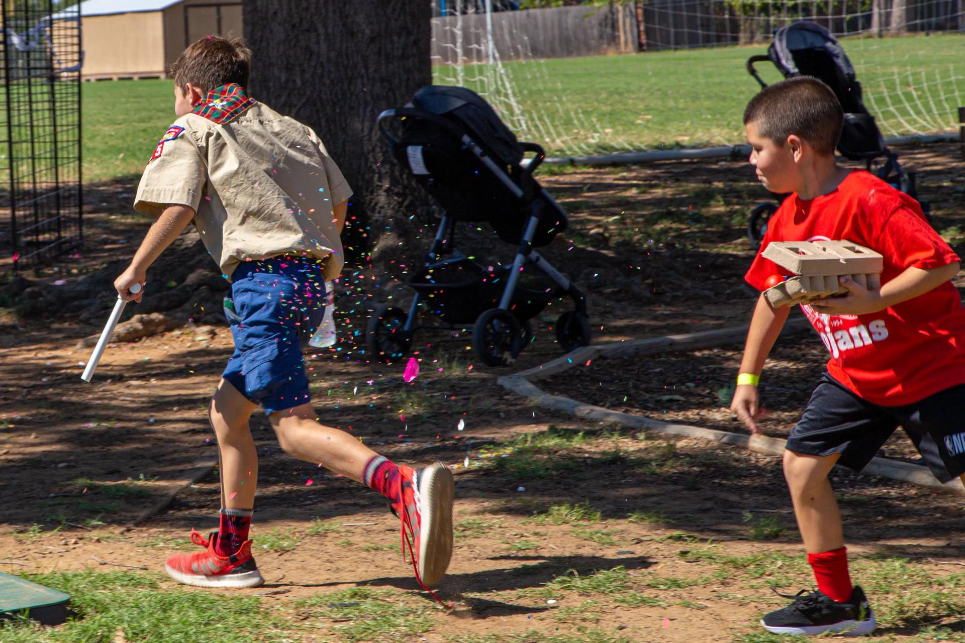 children playing with confetti-filled eggs at GorettiFest festival